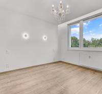 An empty room with a wooden floor, a chandelier, and a large window, 4-room apartment.
