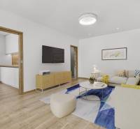Living room with a sofa, paintings, and a television in a 4-room apartment.