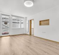 Bright living room with wooden flooring in a 4-room apartment.