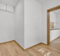 Interior of a 4-room apartment with wooden flooring and a transition to the kitchen.