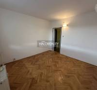 The entrance hall in a 3-room apartment with two open doors to the rooms.