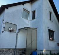 A family house in Lučenec with an elevated entrance and a basketball hoop.
