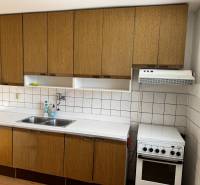 A kitchen with appliances and a sink in a family house.