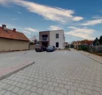 A parking lot with two cars in front of the offices on Široká Street in Nitra.