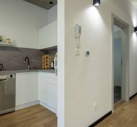 A kitchen unit in offices with modern appliances and wooden flooring.