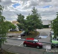 Parking lot on Žitavská Street in Senec with cars and trees.