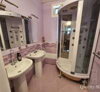 A bathroom in a 2-room apartment with two sinks and a hydromassage shower.