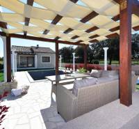 The garden of a family house in Bibinje with a gazebo and a pool on the terrace.