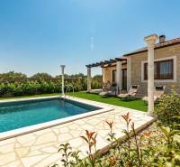 A family house in Bibinje with a pool, terrace, and sun loungers in the garden.