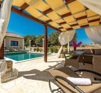 A terrace in a family house in Bibinje with a swimming pool and rattan furniture.