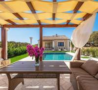 A family house in Bibinje with a gazebo, a pool, and a beautiful garden seating area.