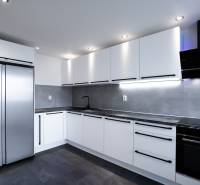 The kitchen in a 3-room apartment on Boriny Street with gray and white elements.
