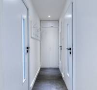 A narrow hallway with white doors in a 3-room apartment on Boriny Street.