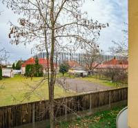 View from the window of gardens, houses, and fencing on Boriny Street in Dunajská Streda.