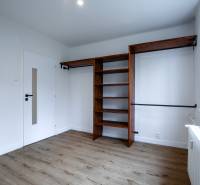 A room on Boriny Street in a 3-room apartment with wooden flooring and shelves.
