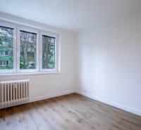 An empty room with a wooden floor and a window in a 3-room apartment on Boriny Street.