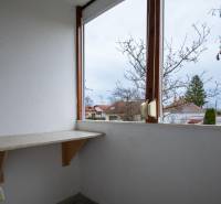 Renovated balcony in a 3-room apartment on Boriny Street with a view of the trees.