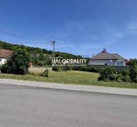Plots - housing in Smolenice, road, houses and greenery in the background.