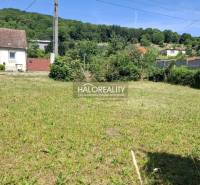 Plots - housing in Smolenice surrounded by greenery, with a country house nearby.