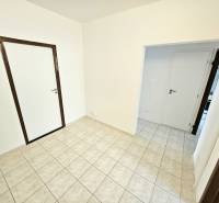 Interior of a 3-room apartment with white walls and tiles.