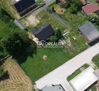 Aerial view of residential plots in Malatíny with buildings and greenery.