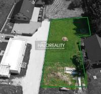 A view of a plot of land in Malatíny suitable for living, with surroundings and access road.