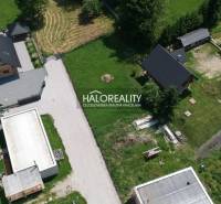 Aerial view of residential plots in Malatíny with houses and green areas.
