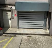 Garages on Budyšínska Street, Bratislava - Nové Mesto, with sectional doors and entrance.