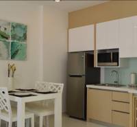 Kitchen and dining area in a 2-room apartment with four chairs and decoration.