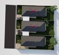 A top view of three single-story family houses with garages and gardens in Veselé.