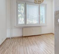 A room in a 4-room apartment with laminate flooring, a large window, and a radiator.