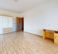 Bedroom in a 4-room apartment with wooden flooring and a wardrobe.
