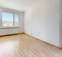 A bright room with large windows and wooden flooring in a 4-room apartment.