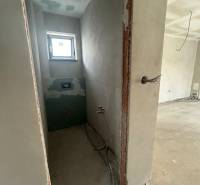 Unfinished bathroom in a family house with a window and installation.