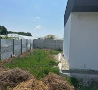 A family house in Žihárec with a yard featuring greenery and fencing.