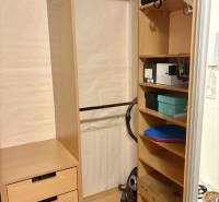 Wooden wardrobe with shelves and a hanger, drawers for accessories, storage space in a 2-room apartment.