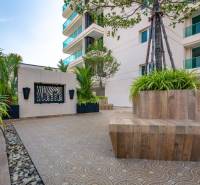 Construction of apartments in Pattaya with modern architecture and greenery around the buildings.