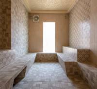 Steam sauna with tiles and seating, Apartment construction.