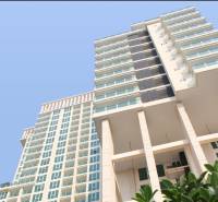 Apartment construction in Pattaya, a high-rise building with glass windows and balconies.