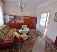 Living room in a family house with retro furniture and patterned carpets.