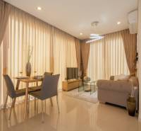 Living room in a 2-room apartment with a dining table and a sofa.