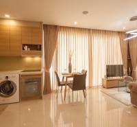 2-room apartment with a kitchen, living room, and dining area, with light-filtering curtains.