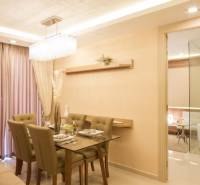 Dining area in a 3-room apartment with elegant lighting and a set table.