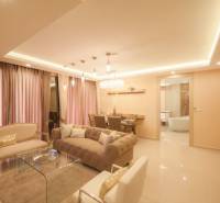 Luxury interior of a 3-room apartment with a comfortable sofa and a dining table.