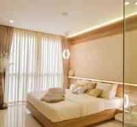 Stylish bedroom in a 3-room apartment with sheer curtains and wooden elements.