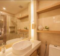Elegant bathroom with a bathtub, sink, and mirror in a 3-room apartment.