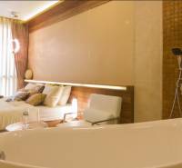 Luxury bedroom with a whirlpool in a 3-room apartment, harmonious combination of wood and natural shades.