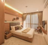 Interior of a 3-room apartment with an elegant bedroom, wooden furniture, and a large window with impressive curtains.