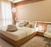 Bright bedroom with a comfortable bed in a 3-room apartment, modern furniture in neutral colors.