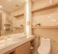 Bathroom of a 3-room apartment with a sink, mirror, and toilet.